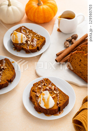 Pumpkin bread freshly baked topped with whipped cream, Thanksgiving dessert 129560703