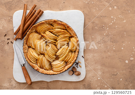 French apple pie or tart with apple slices arranged on top 129560725
