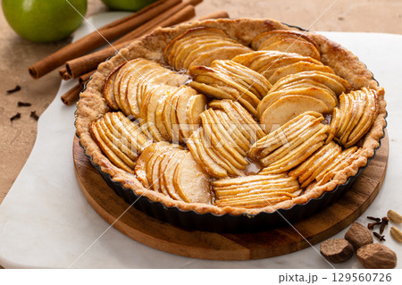 French apple pie or tart with apple slices arranged on top French apple pie or tart with apple slices arranged on top 129560726