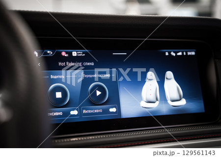 Infotainment screen in a Mercedes AMG showing seat massage controls, Apple CarPlay connectivity, and detailed seat adjustment options. 129561143