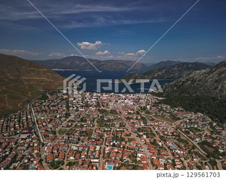 Aerial view of marmaris spreading to a vivid bay and rugged hills, Turkiye Aerial view of marmaris spreading to a vivid bay and rugged hills, Turkiye 129561703