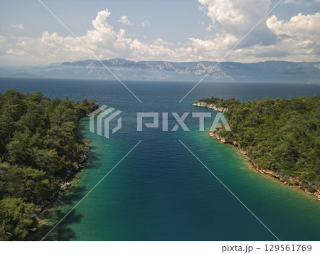 Aerial view narrow channel opening to gokova bay with distant mountains, Turkey 129561769