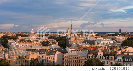 Riga, Latvia skyline at sunset featuring the Riga TV Tower, historic Jugendstil architecture, lush greenery, and a colorful evening sky. Riga, Latvia skyline at sunset featuring the Riga TV Tower, historic Jugendstil architecture, lush greenery, and a colorful evening sky. 129561913