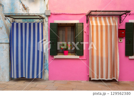 Pink house facade with flowers Burano Venice Italy 129562380