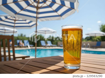 プールサイドのパラソルの下で冷えたビールを楽しむ1　AI生成画像 129563290