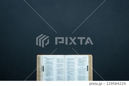 Open bible on top of dark surface. Open bible on top of dark surface. 129564224