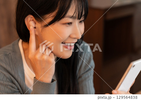 スマホで動画を見る女性 129564838