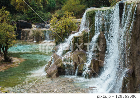 Cascading Waterfall and Emerald Stream in Blue Moon Valley, Lijiang, China Cascading Waterfall and Emerald Stream in Blue Moon Valley, Lijiang, China 129565080