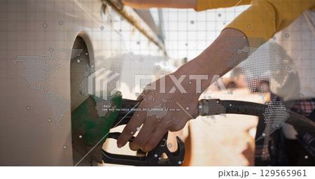 Image of world map and globe over caucasian women refueling 129565961