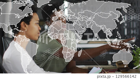 Image of world map over diverse business people in office Image of world map over diverse business people in office 129566142