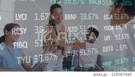 Image of financial data and graphs over diverse female coworkers in office 129567480