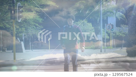 Image of clouds over african american businessman walking Image of clouds over african american businessman walking 129567524