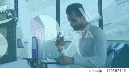 Image of financial data processing over businessman working in office 129567546
