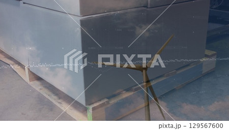 Image of wind turbine and warehouse over data processing 129567600