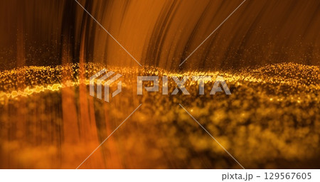 Image of orange light over undulating golden particles on black background Image of orange light over undulating golden particles on black background 129567605