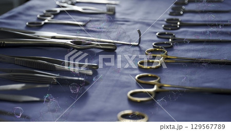 Image of dna strand over surgical instruments Image of dna strand over surgical instruments 129567789
