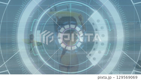 Floating woman wearing bikini with hair in bun relaxing on yellow-green float at sea, HUD overlay 129569069