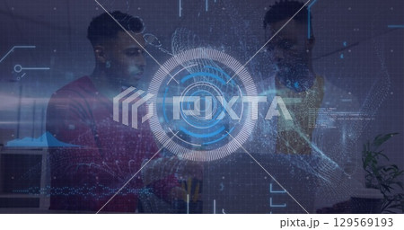 Professionals collaborating around laptop in modern office, with holographic data visualization Professionals collaborating around laptop in modern office, with holographic data visualization 129569193