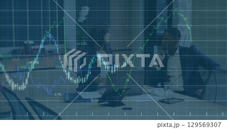 Image of graphs over diverse businesspeople in office 129569307