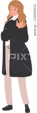 shivering woman wearing long coat and warm sweater. freezing temperature 129569352