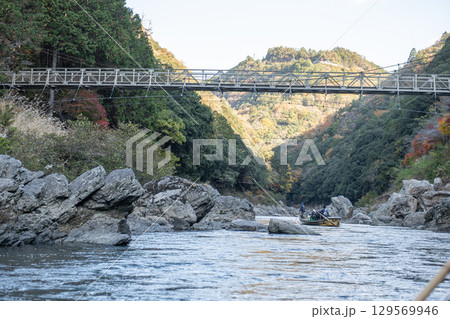 Scenic river view with a bridge and mountains. at Hozugawa River 129569946