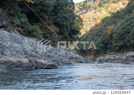 Serene river flowing between rocky banks at Hozugawa River 129569947