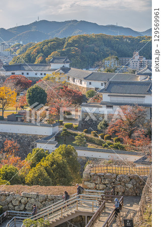 Scenic view of autumn landscape with buildings and hills at Himeji castle, Japan Scenic view of autumn landscape with buildings and hills at Himeji castle, Japan 129569961
