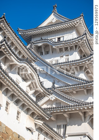 Himeji castle, Elegant Asian architecture against blue sky at Himeji, Japan 129569973