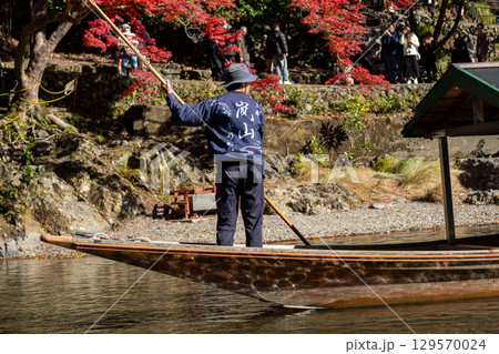 Scenic boat ride among autumn foliage at Hozugawa River 129570024