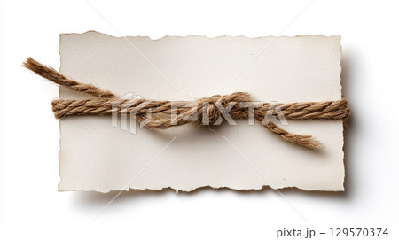 A blank rustic note card with torn edges, tied with a vintage twine rope, isolated on a white background 129570374