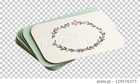 A stack of blank wedding invitation or place cards with a delicate floral wreath design and copy space 129570377