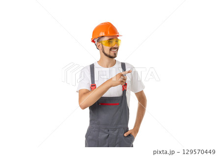 Worker in hard hat and goggles gestures, isolated on white, PNG 129570449