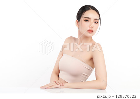 A beautiful young Asian woman with clean, fresh skin against a white background. Skincare, facial treatment, cosmetology, beauty, and spa. An elegant portrait of an Asian woman. A beautiful young Asian woman with clean, fresh skin against a white background. Skincare, facial treatment, cosmetology, beauty, and spa. An elegant portrait of an Asian woman. 129570522