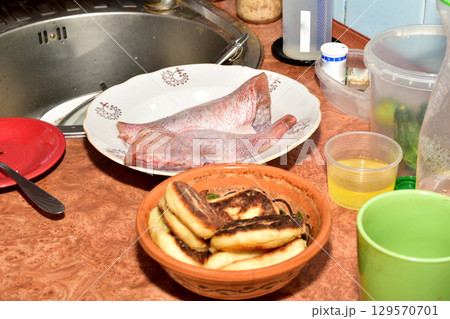 Storing food on the kitchen counter. 129570701