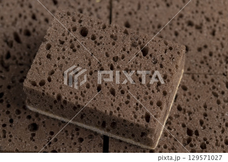 brown sponge for washing dishes and other objects, a synthetic sponge with lots of holes for good foaming of detergents and is used for cleaning 129571027