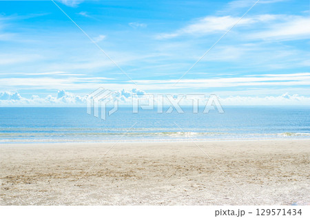 Sunny beach with clear blue sky and calm sea. 129571434