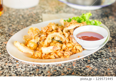 Crispy fried calamari with dipping sauce Crispy fried calamari with dipping sauce 129571445