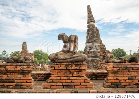 Wat Chaiwatthanaram temple, Ayutthaya historical park, Ayutthaya, Thailand Ancient temple ruins with a Buddha statue Wat Chaiwatthanaram temple, Ayutthaya historical park, Ayutthaya, Thailand Ancient temple ruins with a Buddha statue 129571476