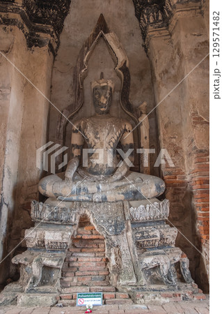 Wat Chaiwatthanaram temple, Ayutthaya historical park, Ayutthaya, Thailand Ancient Buddha statue in a temple setting Wat Chaiwatthanaram temple, Ayutthaya historical park, Ayutthaya, Thailand Ancient Buddha statue in a temple setting 129571482