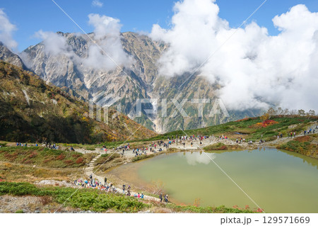 Happo pond, Happo Alpen Line Nature trail, Hakuba, Nagano, Japan, Scenic mountain landscape with a tranquil lake Happo pond, Happo Alpen Line Nature trail, Hakuba, Nagano, Japan, Scenic mountain landscape with a tranquil lake 129571669