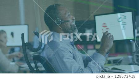 Image of data processing over african american senior man talking on phone headset at office Image of data processing over african american senior man talking on phone headset at office 129572419