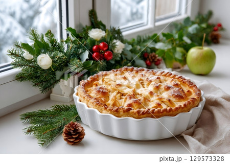 Homemade apple pie resting on windowsill during winter holidays 129573328