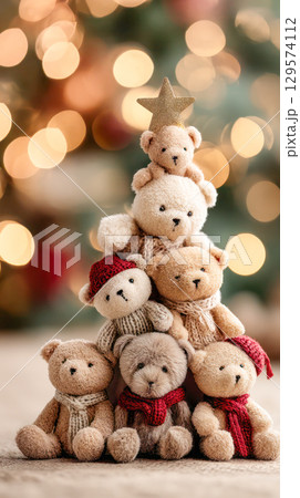 Adorable teddy bears arranged in a festive Christmas tree shape, adorned with a golden star, creating a warm holiday atmosphere 129574112