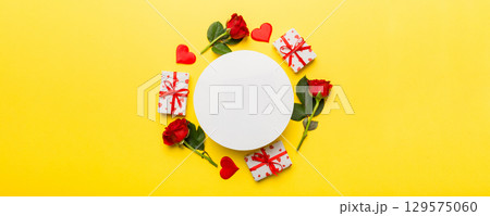 Frame made of rose, git box, heart and blank greeting card mockup on Colored background. Top view, flat lay, copy space Holiday, Mothers Day, birthday concept Frame made of rose, git box, heart and blank greeting card mockup on Colored background. Top view, flat lay, copy space Holiday, Mothers Day, birthday concept 129575060