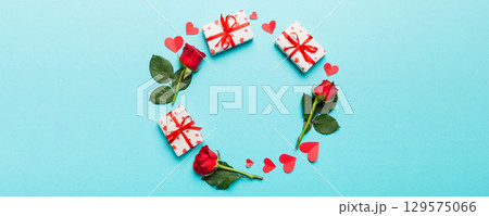 Heart made of rose, git box, heart and blank greeting card mockup on Colored background. Top view, flat lay, copy space Holiday, Mothers Day, birthday concept 129575066