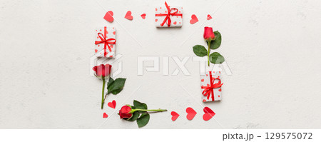 Heart made of rose, git box, heart and blank greeting card mockup on Colored background. Top view, flat lay, copy space Holiday, Mothers Day, birthday concept 129575072