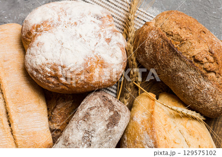 Homemade natural breads. Different kinds of fresh bread as background, perspective view with copy space 129575102