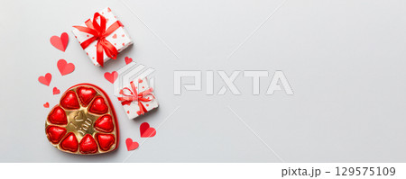 Delicious chocolate pralines in box for Valentine's Day. Heart shaped with gift box of chocolates top view with copy space 129575109