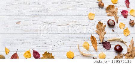 Autumn composition. Pattern made of dried leaves and other design accessories on table. Flat lay, top view 129575133