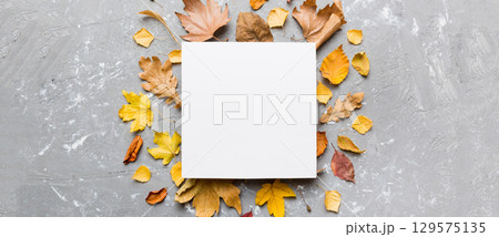 Autumn composition with paper blank and dried leaves on table. Flat lay, top view, copy space Autumn composition with paper blank and dried leaves on table. Flat lay, top view, copy space 129575135